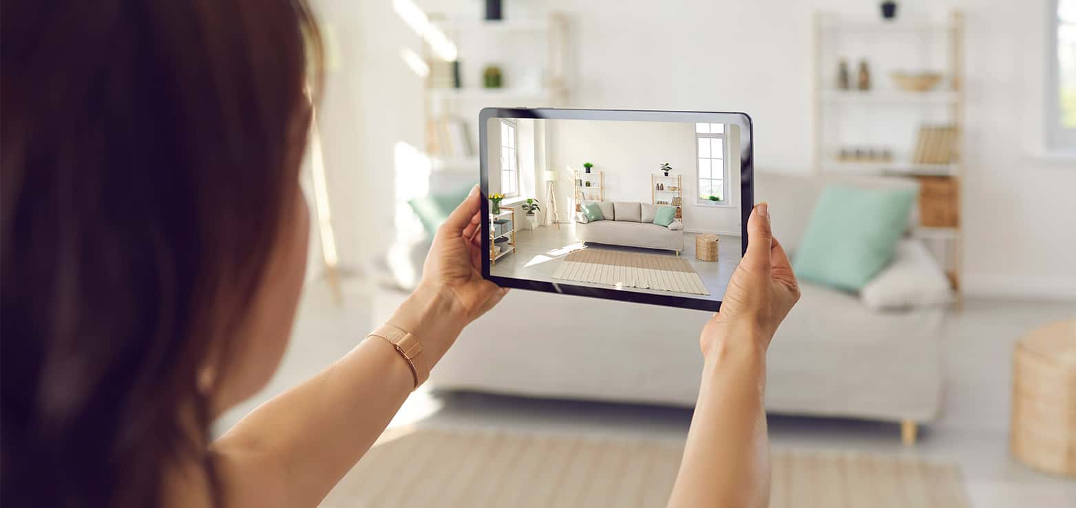 woman taking photo with her tablet to sell her house fast online