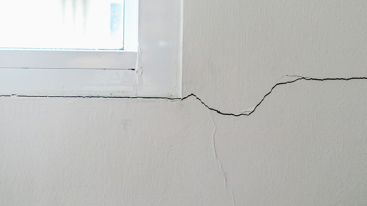 cracked home foundation by the window
