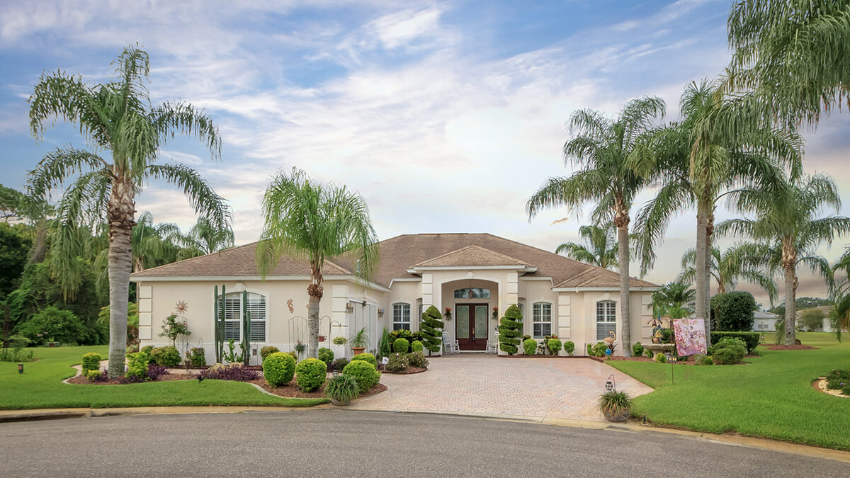 florida house with palms and nice landscaping