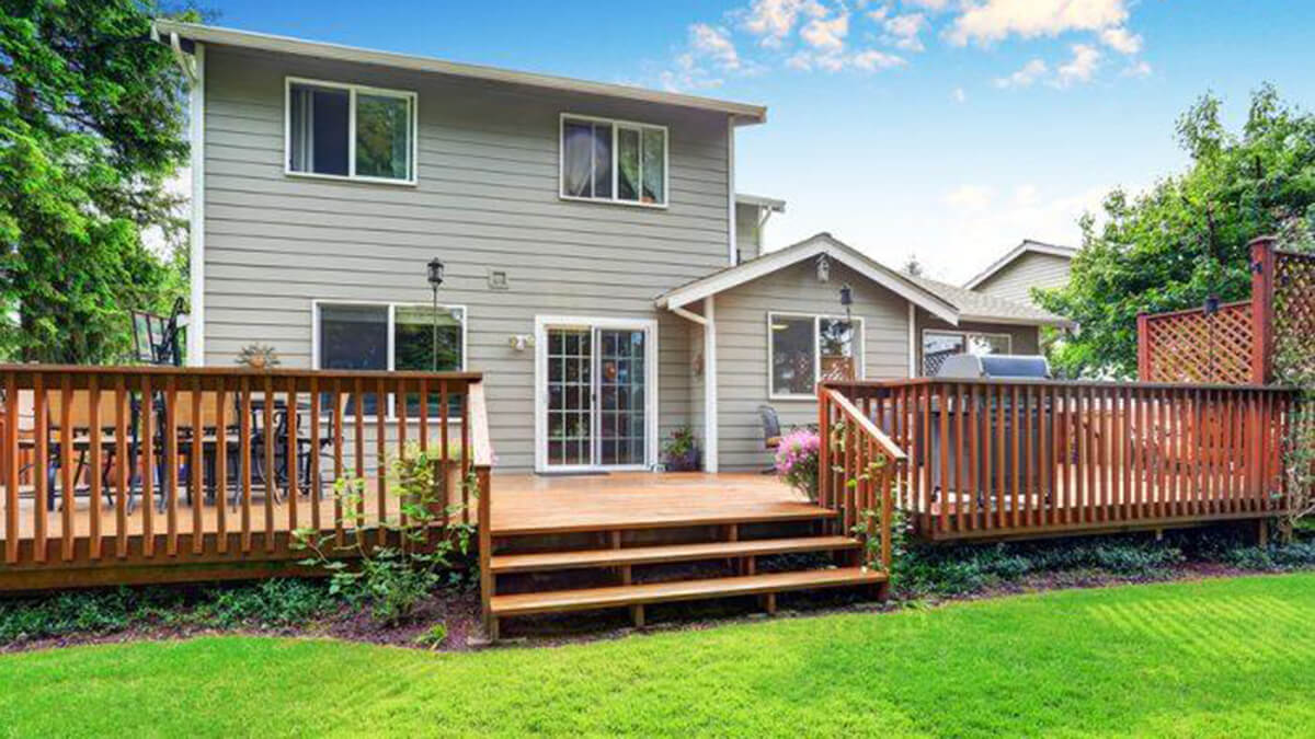 home with mown lawn and beautiful deck