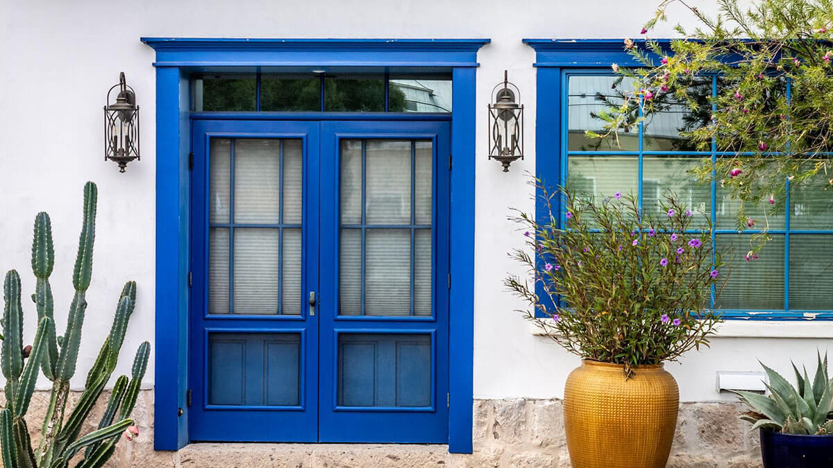 front of a house in tucson arizona with blue door and plants
