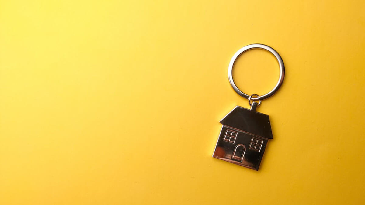 home keychain on yellow background