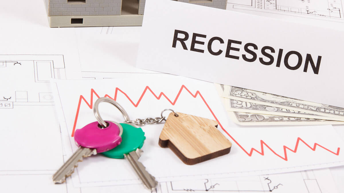 documents representing recession analysis on a table with house keys on top of them