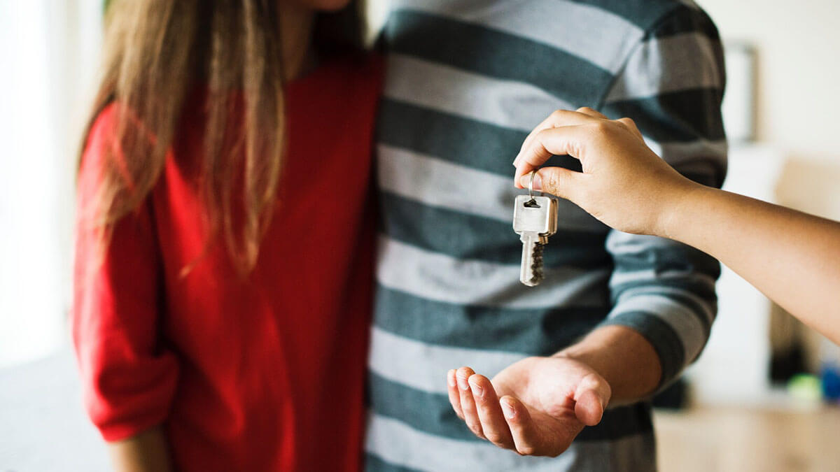 couple obtaining keys for their home by getting their mortgage