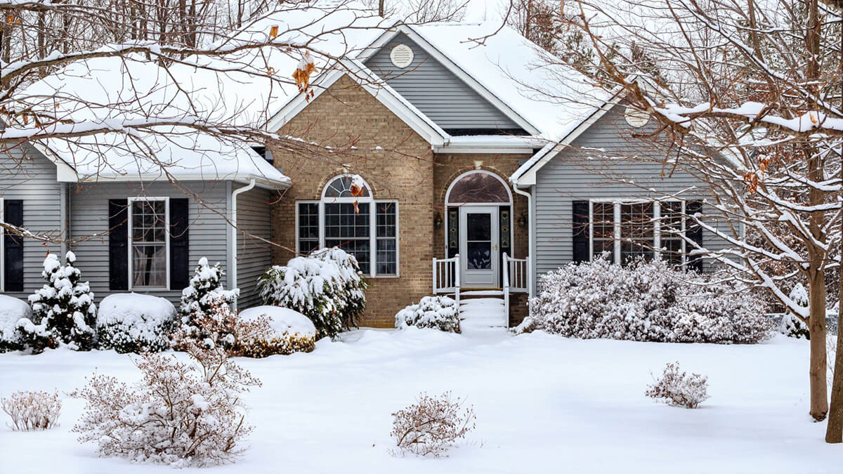 single family home covered by snow during winter