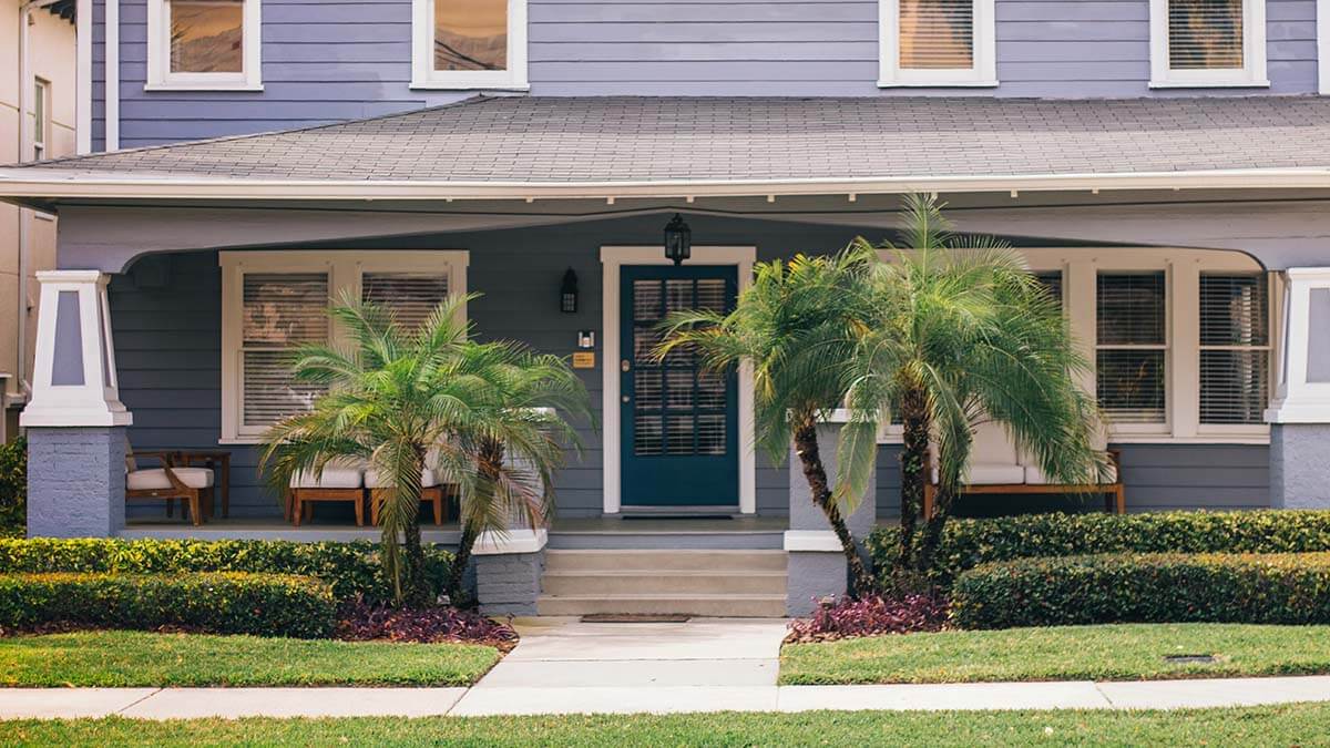 front of a house with blue sidings in Tampa Bay, Florida